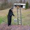 Lifting concrete from the ground to roof with a ladder pulley system. Paoli, Indiana.