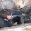 A look inside a chimney where i am building divider walls between my legs so that we can install a cast- in-place masonry lining system. Pekin, Indiana. 