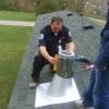Install roof flashing and plum up the class A chimney. Seal flashing and secure it. Paoli, Indiana. 