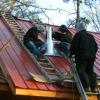 Installing roof flashing and fist section of chimney. Hillham, Indiana.